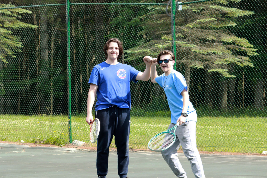 Picture2 – Long Lake Camp For The Arts Two campers enjoy a game of tennis during an afternoon sports activity at Long Lake Camp for the Arts.