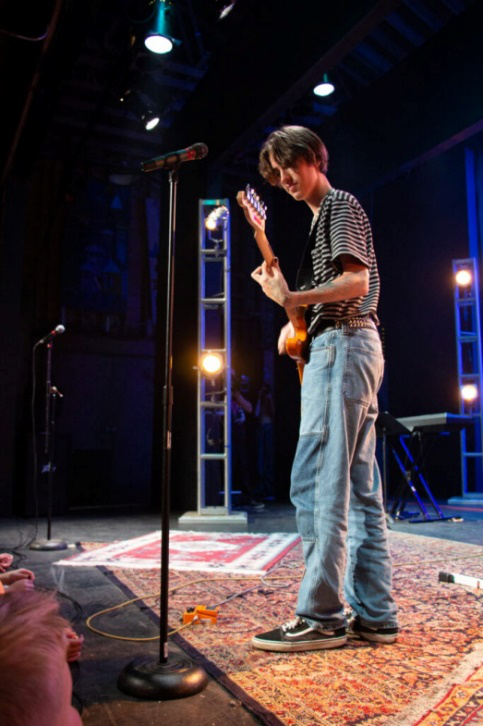 Picture13 – Long Lake Camp For The Arts Teen camper performing on stage with a guitar during Rock Night.
