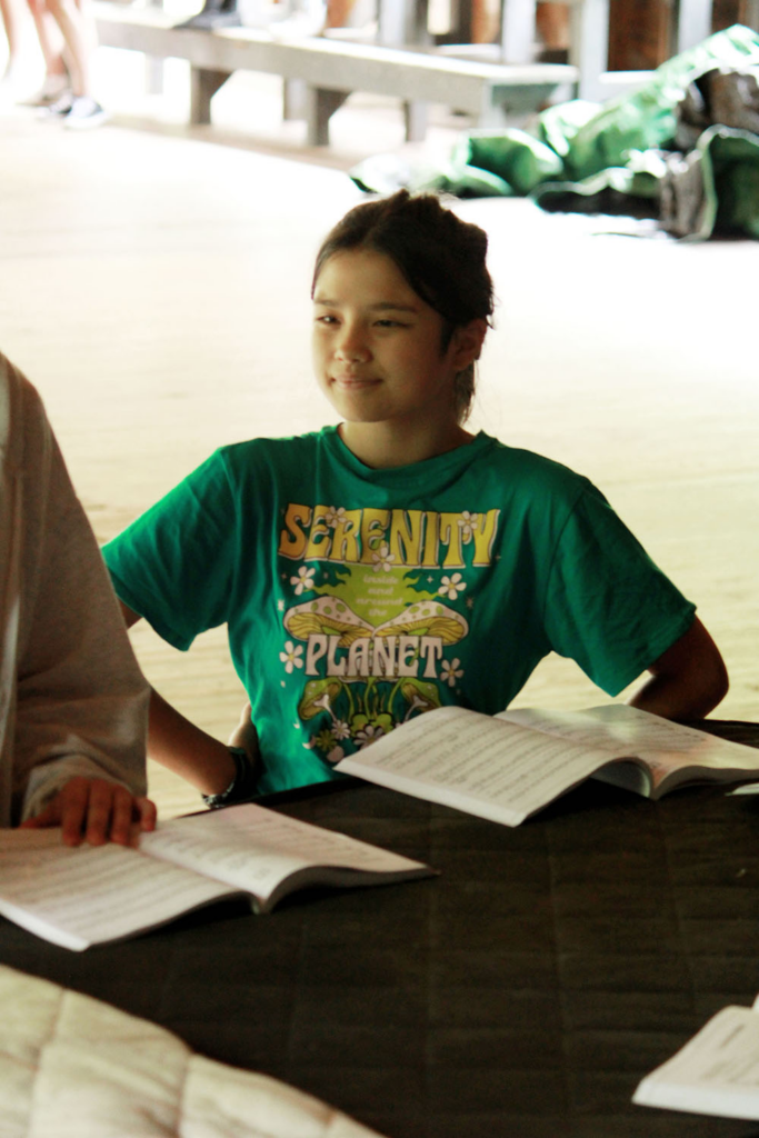 Picture17 – Long Lake Camp For The Arts Girl reading a book during a theatre camp session