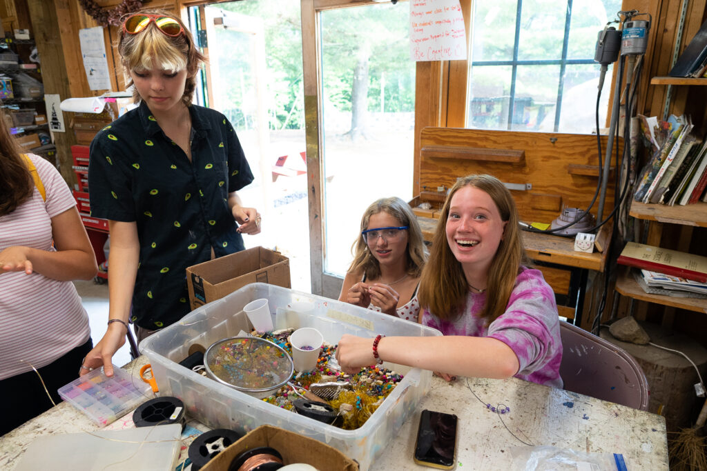 Teen campers painting and enjoying creative art activities together at arts camp.