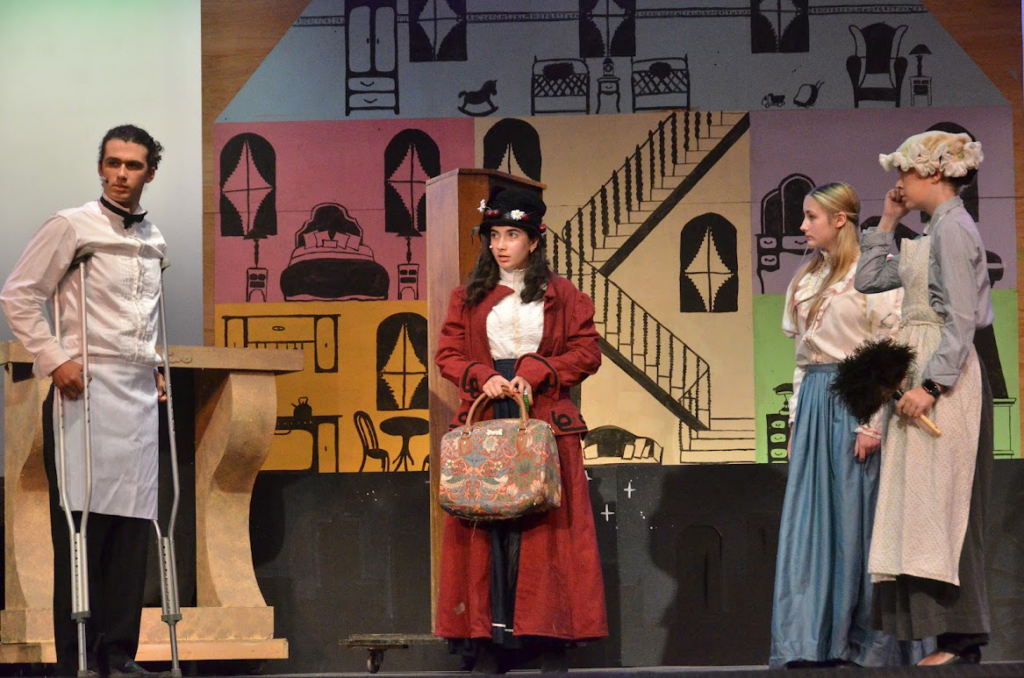 Teen campers performing a theatre scene together on stage