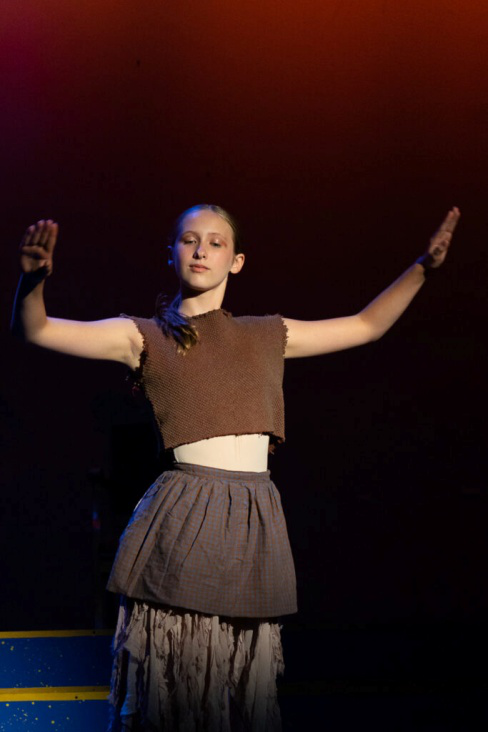 Teen camper performing a dance sequence on stage